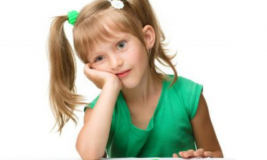 Girl resting head in hands with bored look on her face