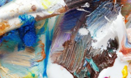 Close up of paint brush and many color paints
